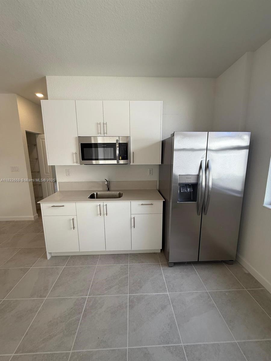 2942 Southeast 23rd Avenue Homestead, FL 33035 - Photo 10 of 20 a kitchen with cabinets stainless steel appliances and a counter space