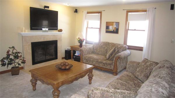 67 Lawton Road Shirley, MA 01464 - Photo 3 of 21 a living room with furniture a flat screen tv and a fireplace