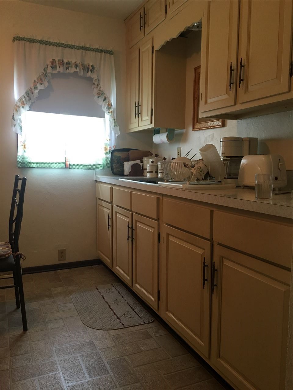 616 Barry Road Rockford, IL 61109 - Photo 5 of 15 a kitchen with sink cabinets and window