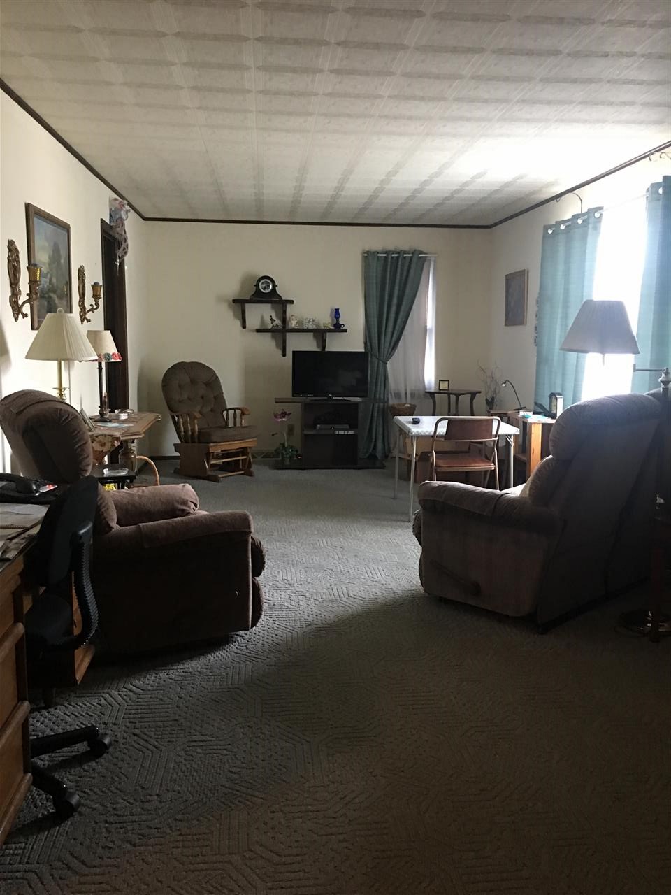 616 Barry Road Rockford, IL 61109 - Photo 8 of 15 a living room with furniture a flat screen tv and a window