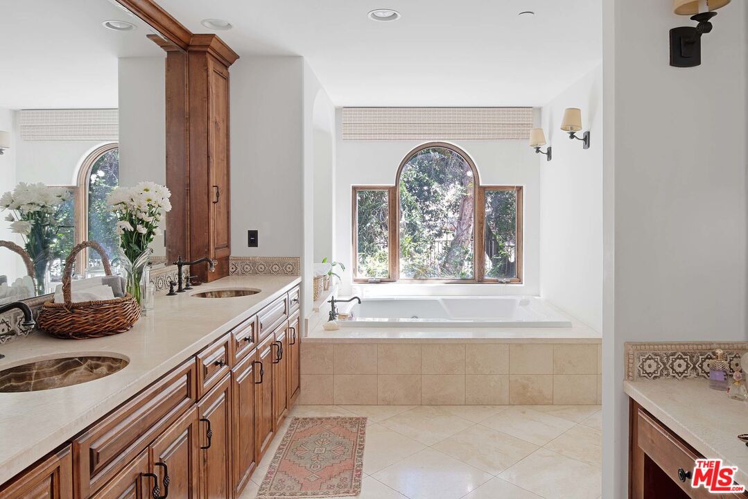 2251 Cold Canyon Road Calabasas, CA 91302 - Photo 18 of 47 a bathroom with a granite countertop sink a mirror and a window
