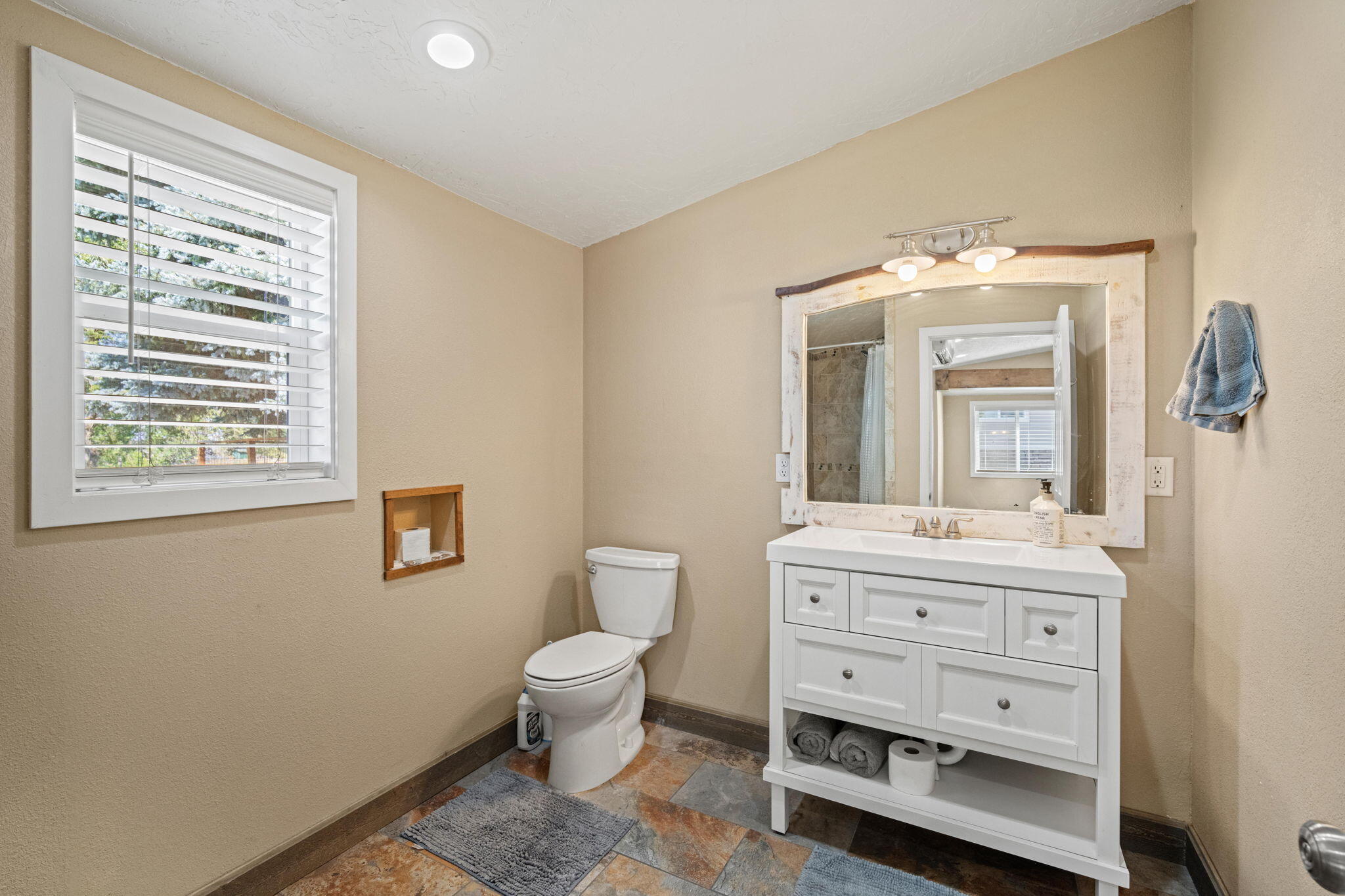 62466 Eagle Road Bend, OR 97701 - Photo 75 of 93 a spacious bathroom with a double vanity sink a mirror and a toilet