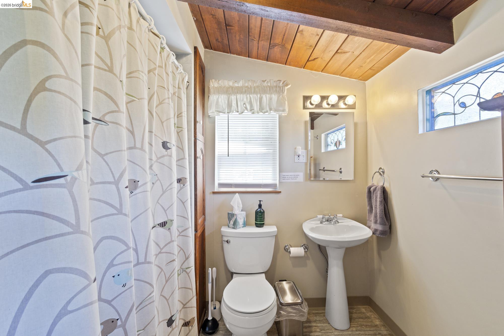 21815 Confidence Road Twain Harte, CA 95383 - Photo 17 of 30 a bathroom with a toilet sink and mirror