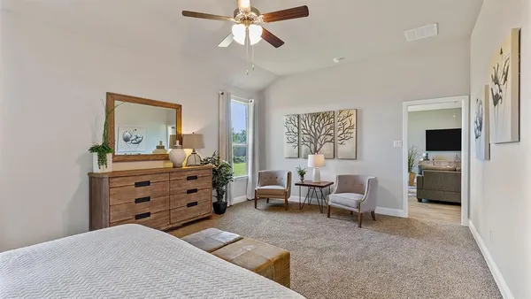 a bedroom with furniture and a large window