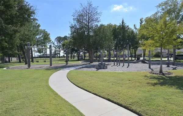 a swimming pool with outdoor seating and garden