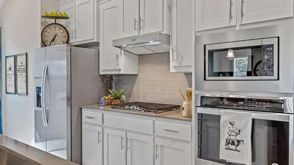 a kitchen with stainless steel appliances a sink a stove and a refrigerator