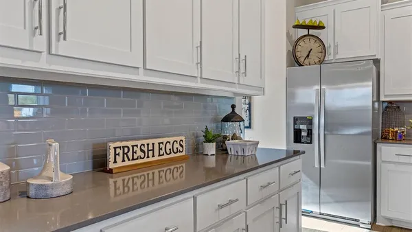 a kitchen with stainless steel appliances granite countertop a stove refrigerator and cabinets
