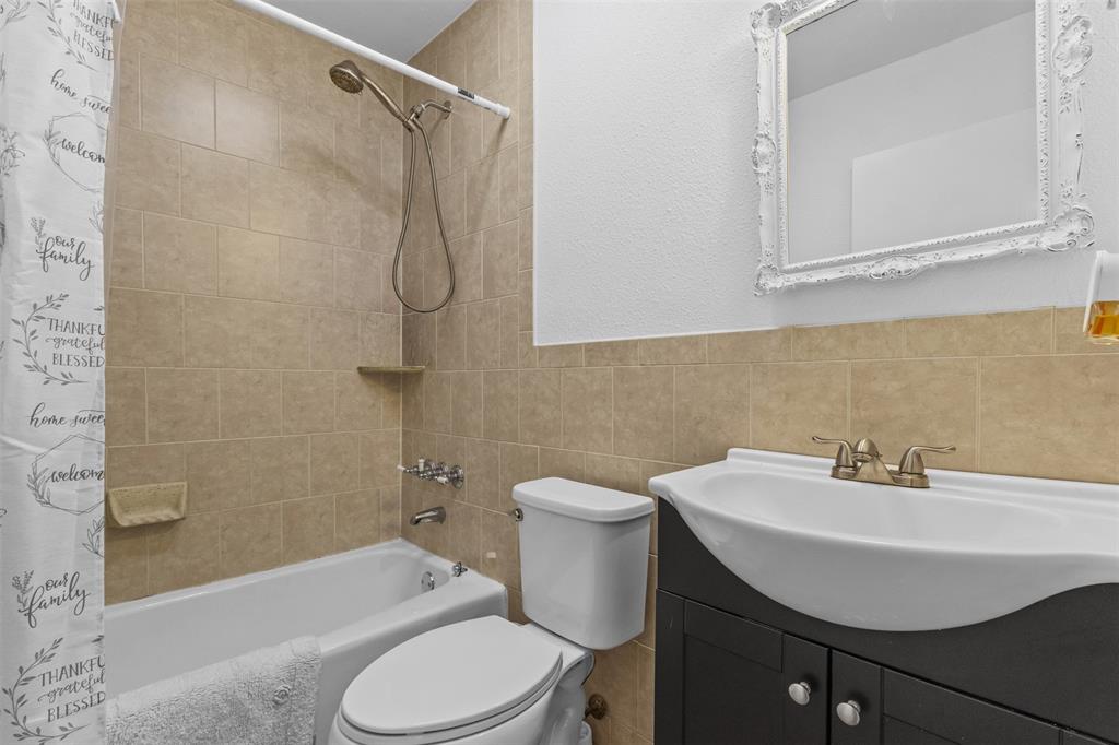1108 Blackland Road Fate, TX 75189 - Photo 11 of 28 a bathroom with a sink toilet and shower