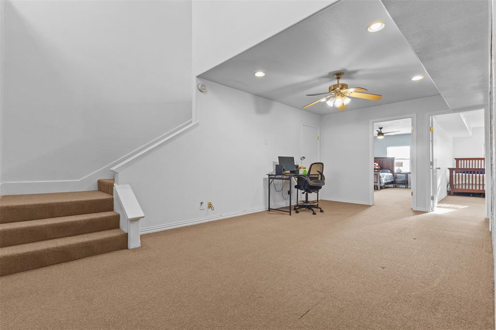 1108 Blackland Road Fate, TX 75189 - Photo 14 of 28 a view of a livingroom with a staircase and a chandelier