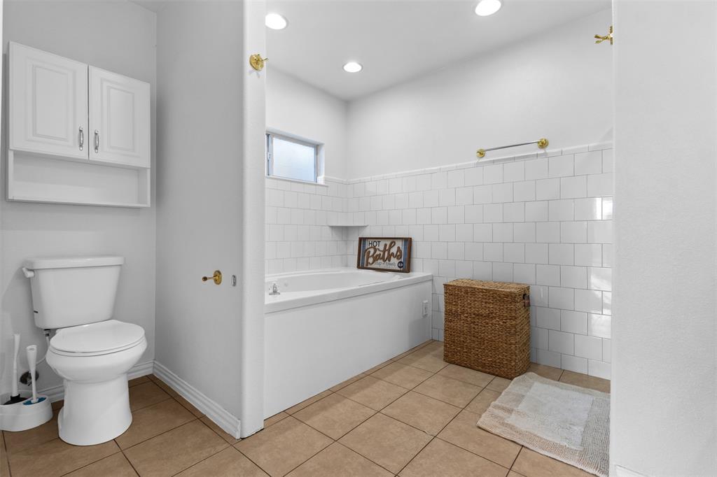 1108 Blackland Road Fate, TX 75189 - Photo 19 of 28 a bathroom with a toilet and a sink