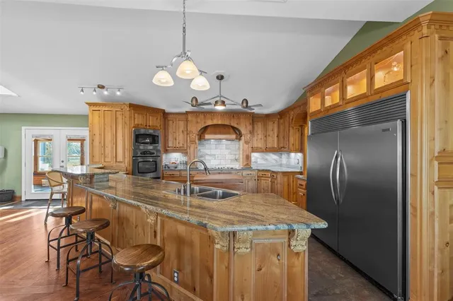 a living room with furniture a chandelier and a flat screen tv