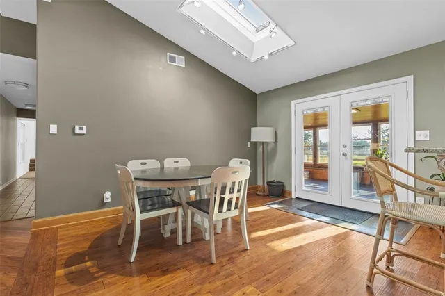 a kitchen with stainless steel appliances granite countertop a sink a refrigerator and a stove