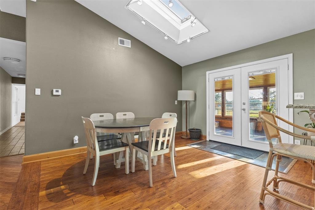 1108 Blackland Road Fate, TX 75189 - Photo 6 of 28 a view of a dining room with furniture and wooden floor