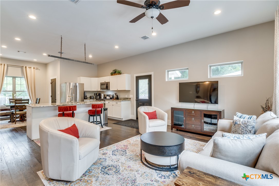 911 Farm Street Bastrop, TX 78602 - Photo 27 of 40 a living room with furniture and a flat screen tv