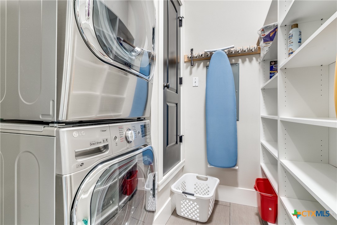 911 Farm Street Bastrop, TX 78602 - Photo 33 of 40 a view of walk in closet with clothes and shoes