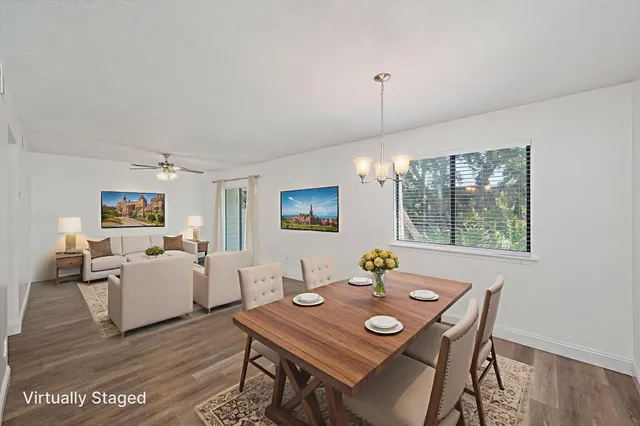 a view of a dining room with furniture window and wooden floor