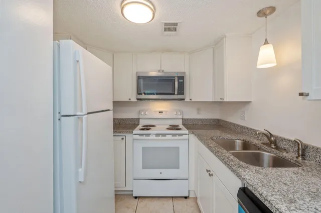 a kitchen with a stove sink and refrigerator