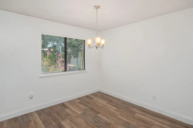 a view of a room with wooden floor and windows