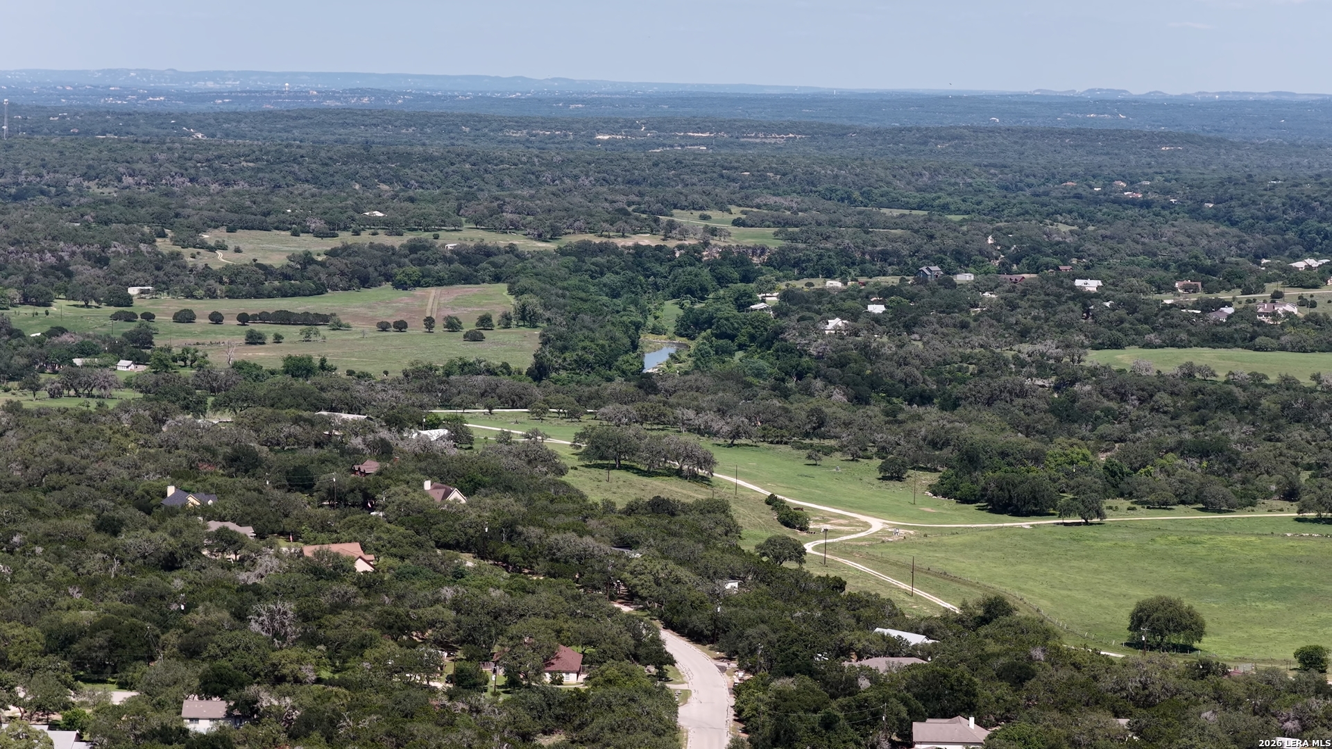 682 Winding River Lane Spring Branch, TX 78070 - Photo 5 of 21 an aerial view of house with yard and mountain view in back