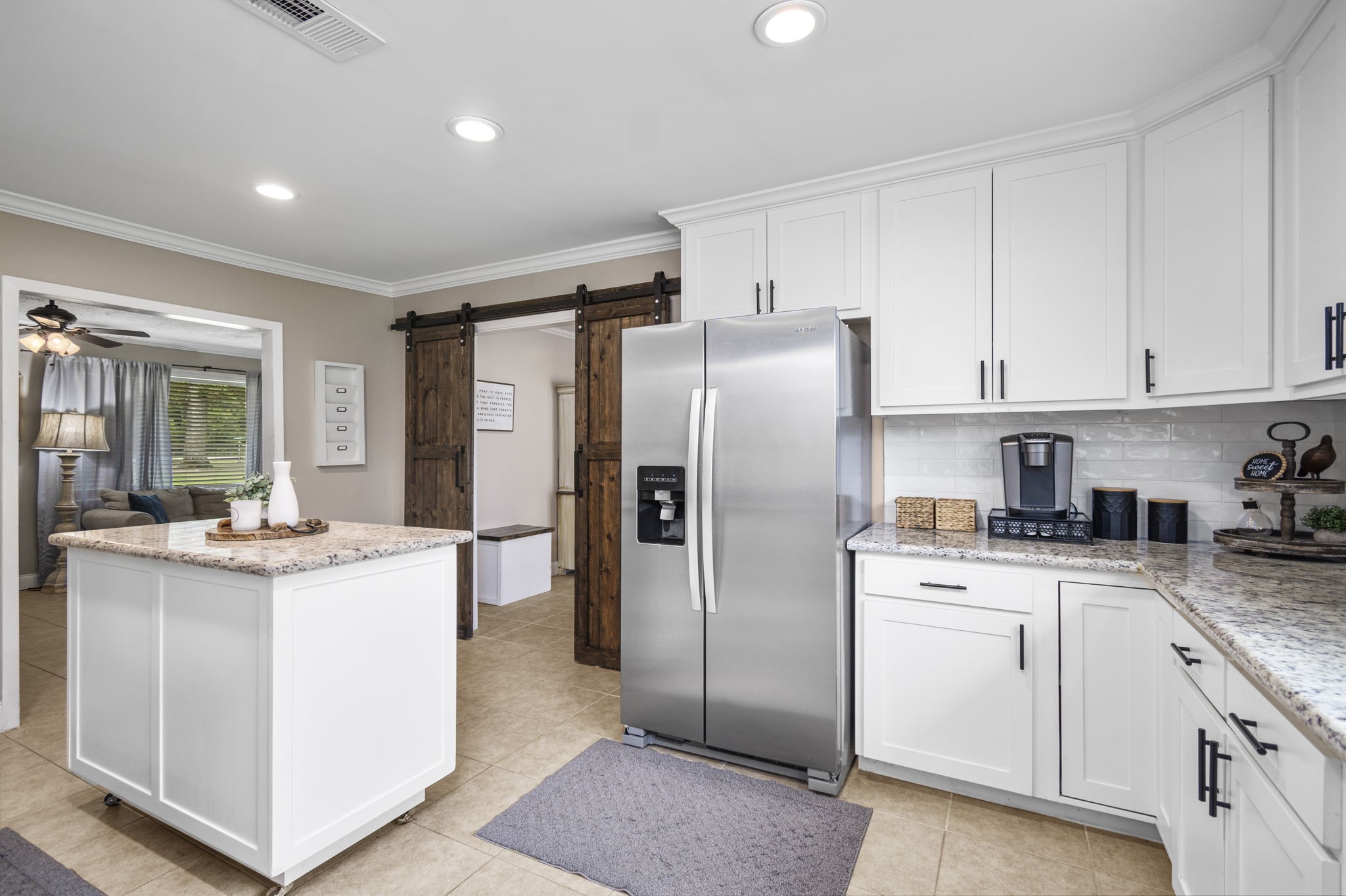 25311 Hardin Store Road Pinehurst, TX 77362 - Photo 11 of 39 a kitchen with white cabinets and stainless steel appliances