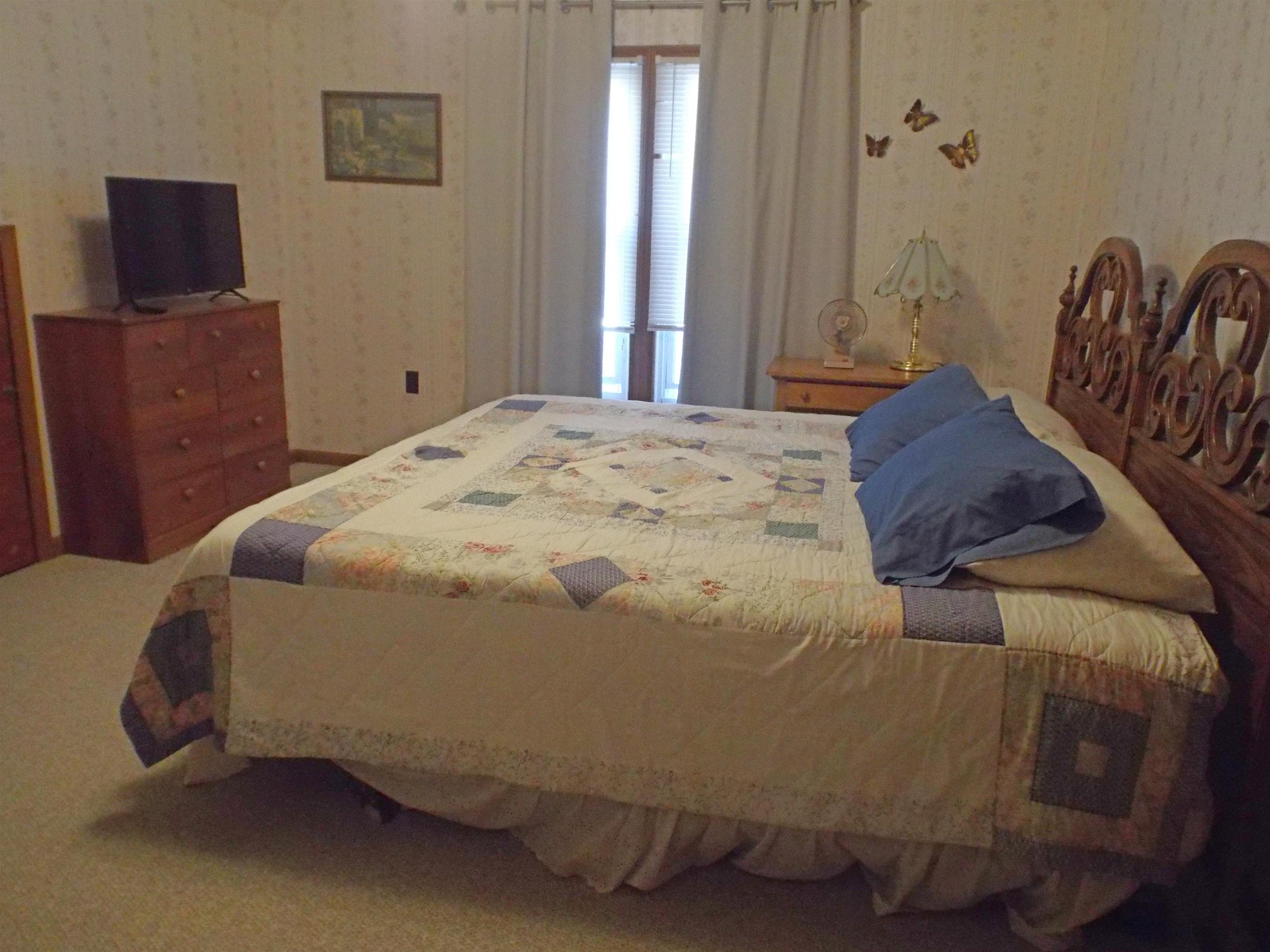 216 South Long Street Warren, IL 61087 - Photo 15 of 19 a bedroom with a bed and window