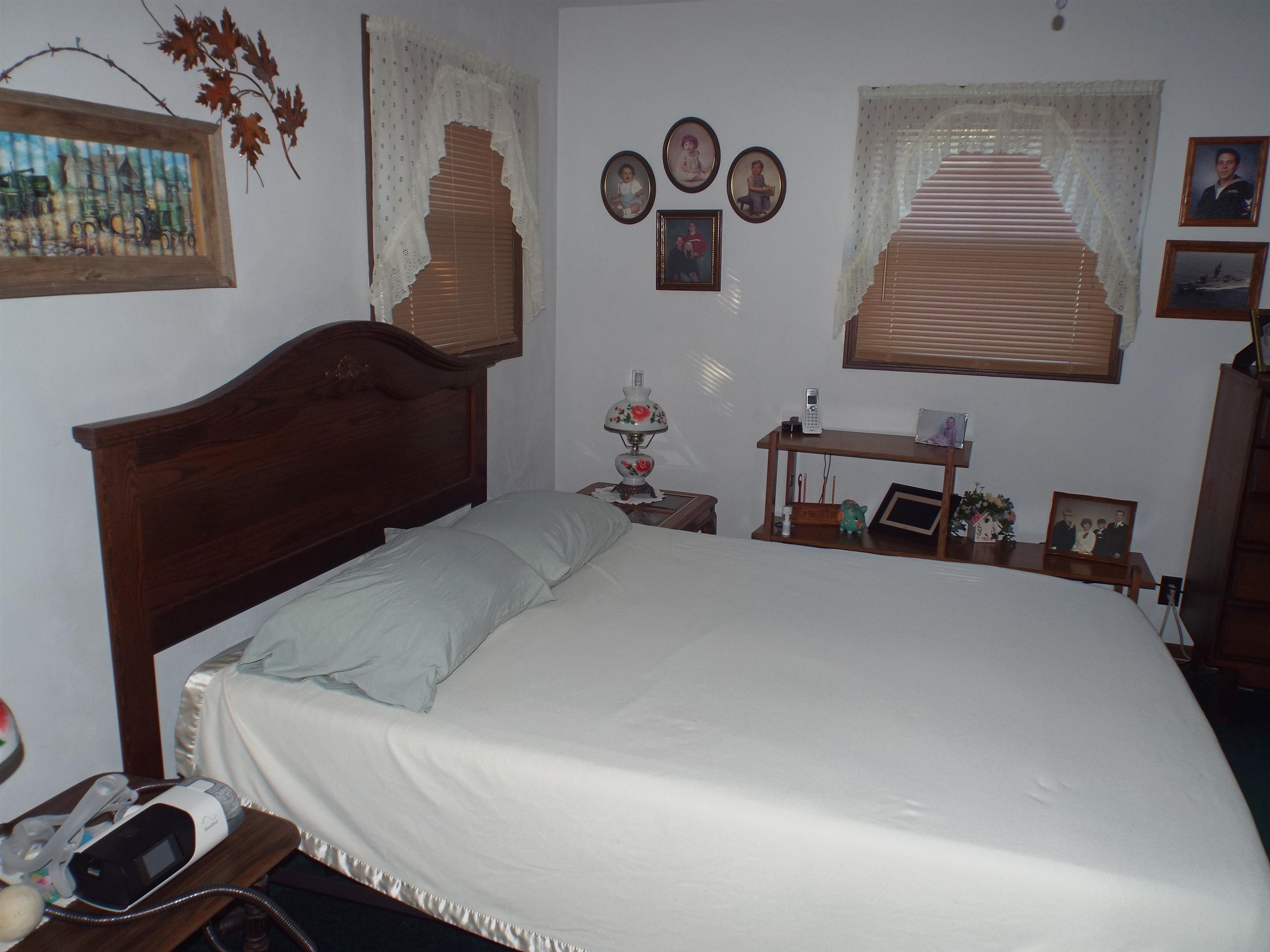 216 South Long Street Warren, IL 61087 - Photo 16 of 19 a bedroom with a bed and a lamp on dresser with it