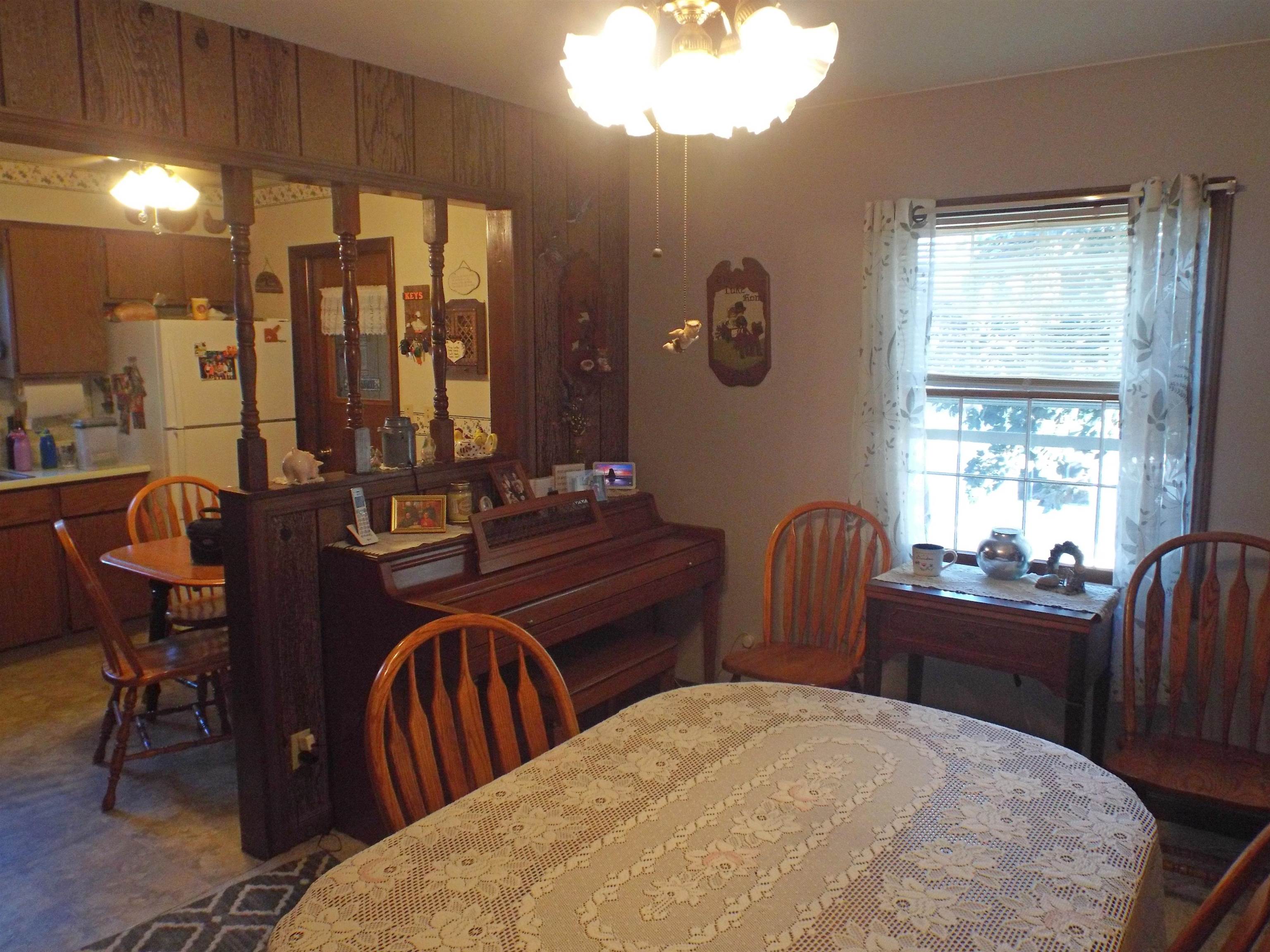 216 South Long Street Warren, IL 61087 - Photo 8 of 19 a room with two chairs a dining table and chairs with wooden floor