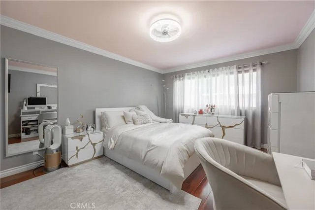 a bedroom with bed and a large window