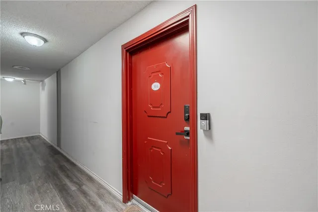 a view of a hallway with wooden floor