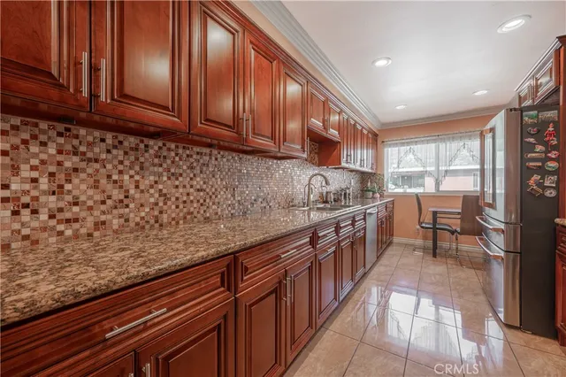 a kitchen with stainless steel appliances granite countertop wooden cabinets a sink and dishwasher