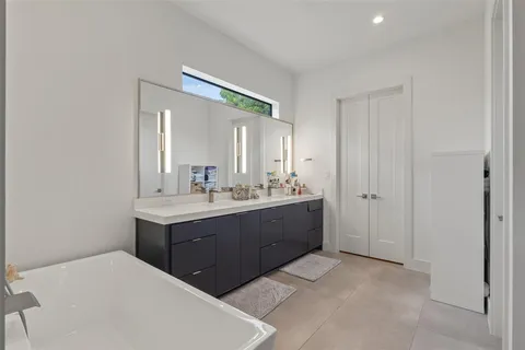 a bathroom with a sink vanity and mirror