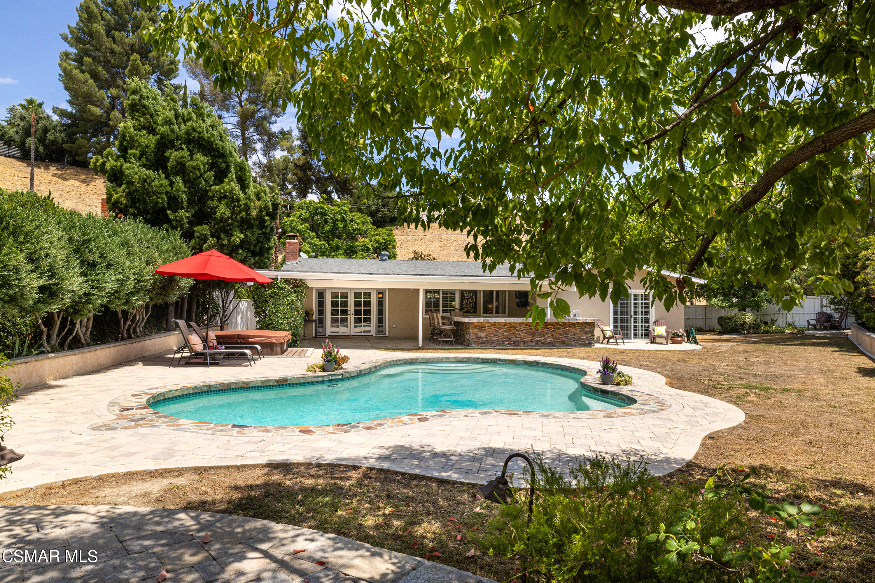 5609 Parkmor Road Calabasas, CA 91302 - Photo 32 of 37 a front view of a house with garden and trees