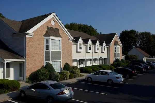 a view of a white house with a yard