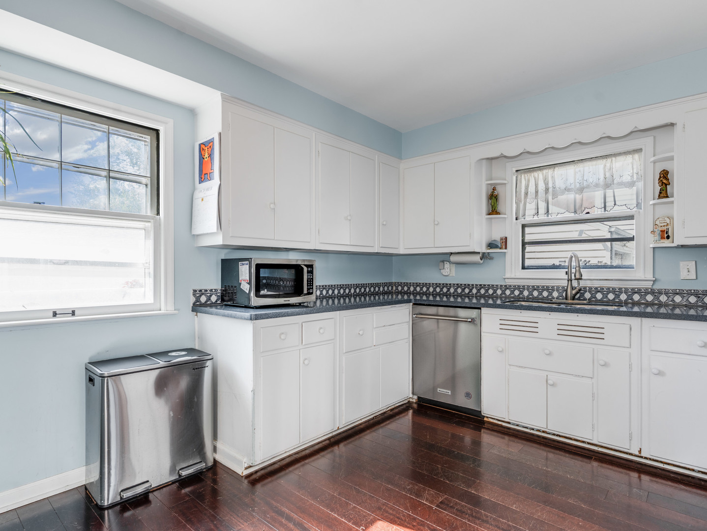 1416 West Acres Road Joliet, IL 60435 - Photo 12 of 30 a kitchen with granite countertop white cabinets and white appliances with wooden floor