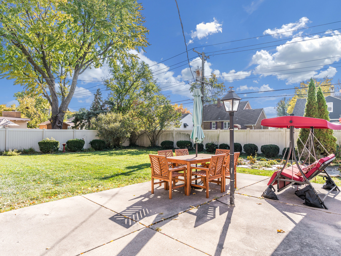 1416 West Acres Road Joliet, IL 60435 - Photo 30 of 30 a view of a patio with a table and chairs under an umbrella