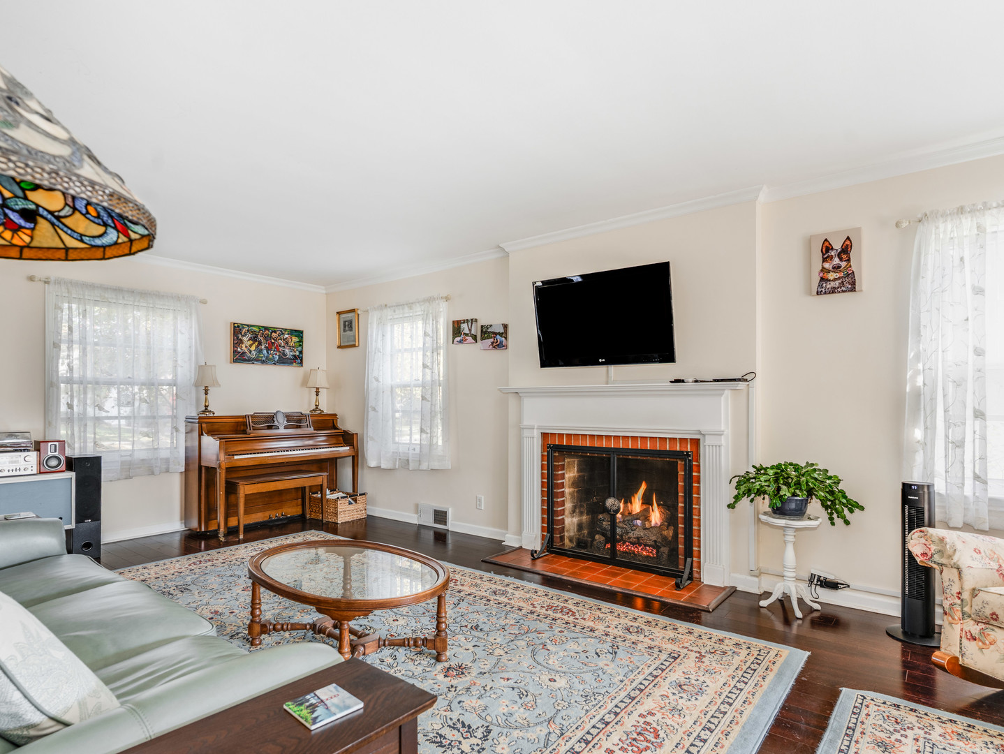1416 West Acres Road Joliet, IL 60435 - Photo 3 of 30 a living room with furniture a flat screen tv and a fireplace