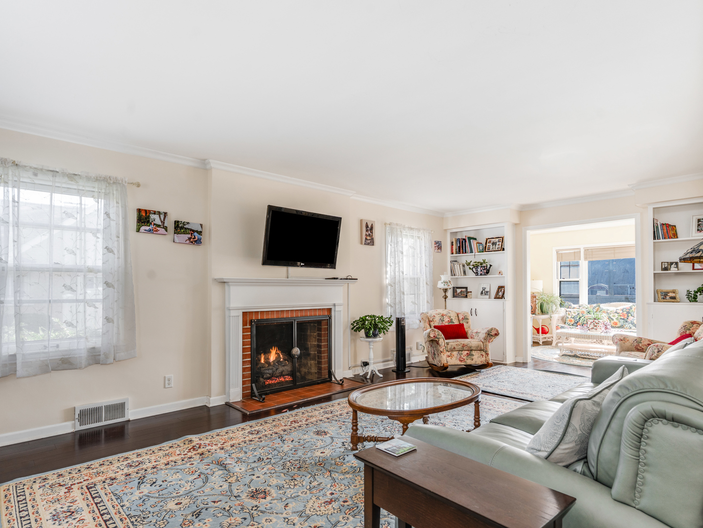 1416 West Acres Road Joliet, IL 60435 - Photo 5 of 30 a living room with furniture a flat screen tv and a fireplace