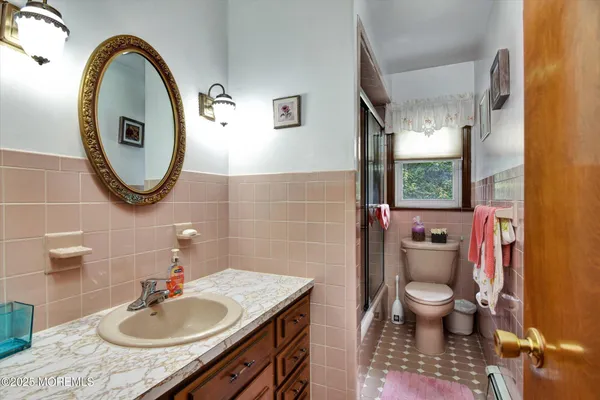 a view of a dining room with furniture a chandelier and wooden floor