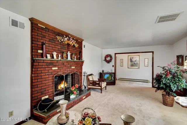 a living room with furniture gym equipment and a fireplace