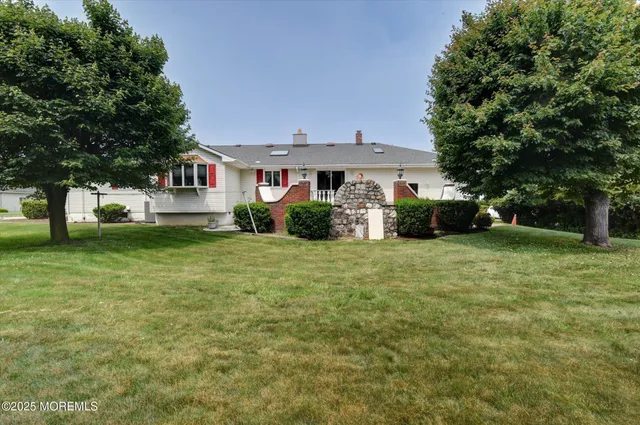 a front view of a house with a garden