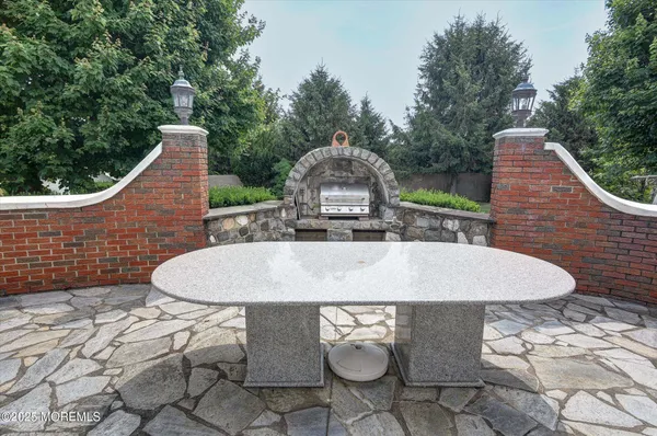 a view of a wooden chairs and table in the back yard of a house