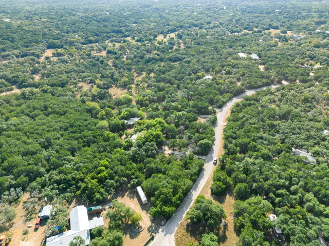 a view of a green field with lots of bushes