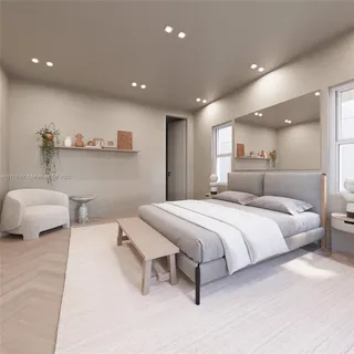 a spacious bedroom with a bed and a couch