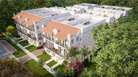 an aerial view of a house with yard and swimming pool