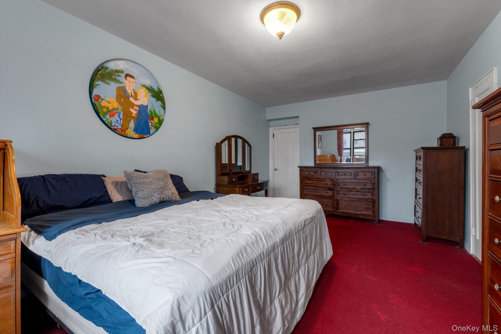 123-35 82nd Road, Unit 5C Queens, NY 11415 - Photo 11 of 21 a bedroom with a bed and a painting on the wall