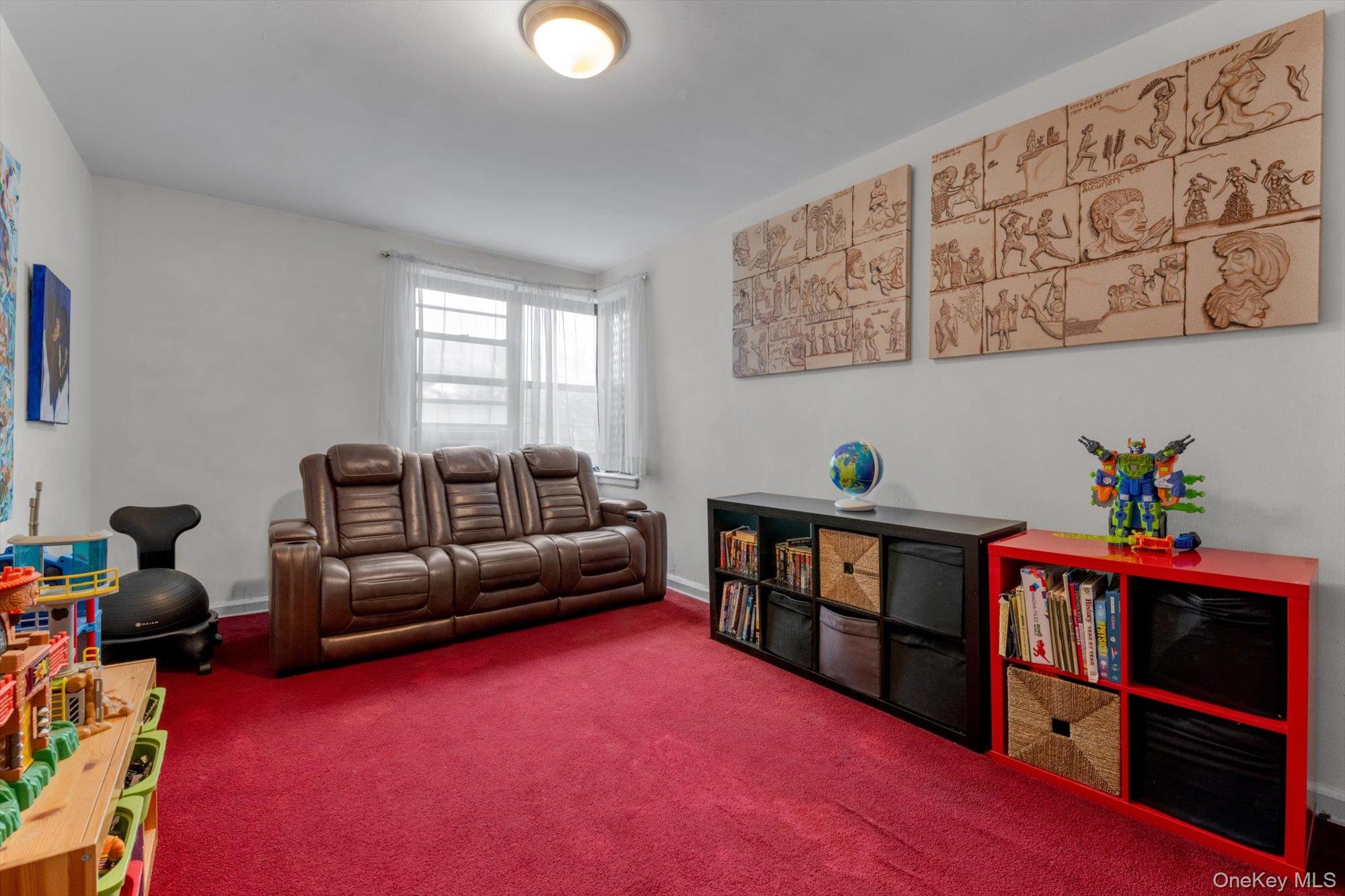 123-35 82nd Road, Unit 5C Queens, NY 11415 - Photo 16 of 21 a living room with furniture and book shelf