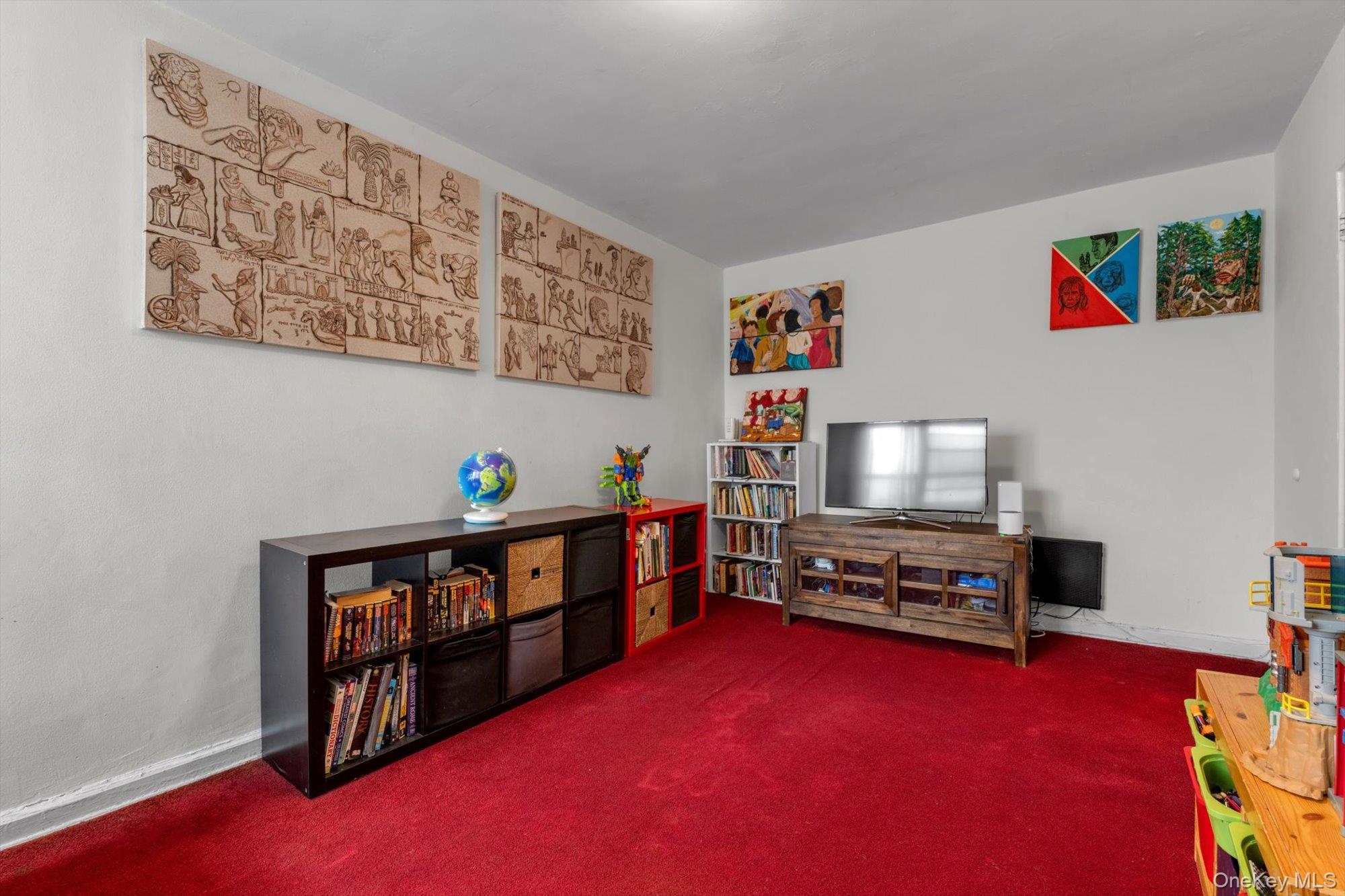 123-35 82nd Road, Unit 5C Queens, NY 11415 - Photo 17 of 21 a living room with furniture and a flat screen tv