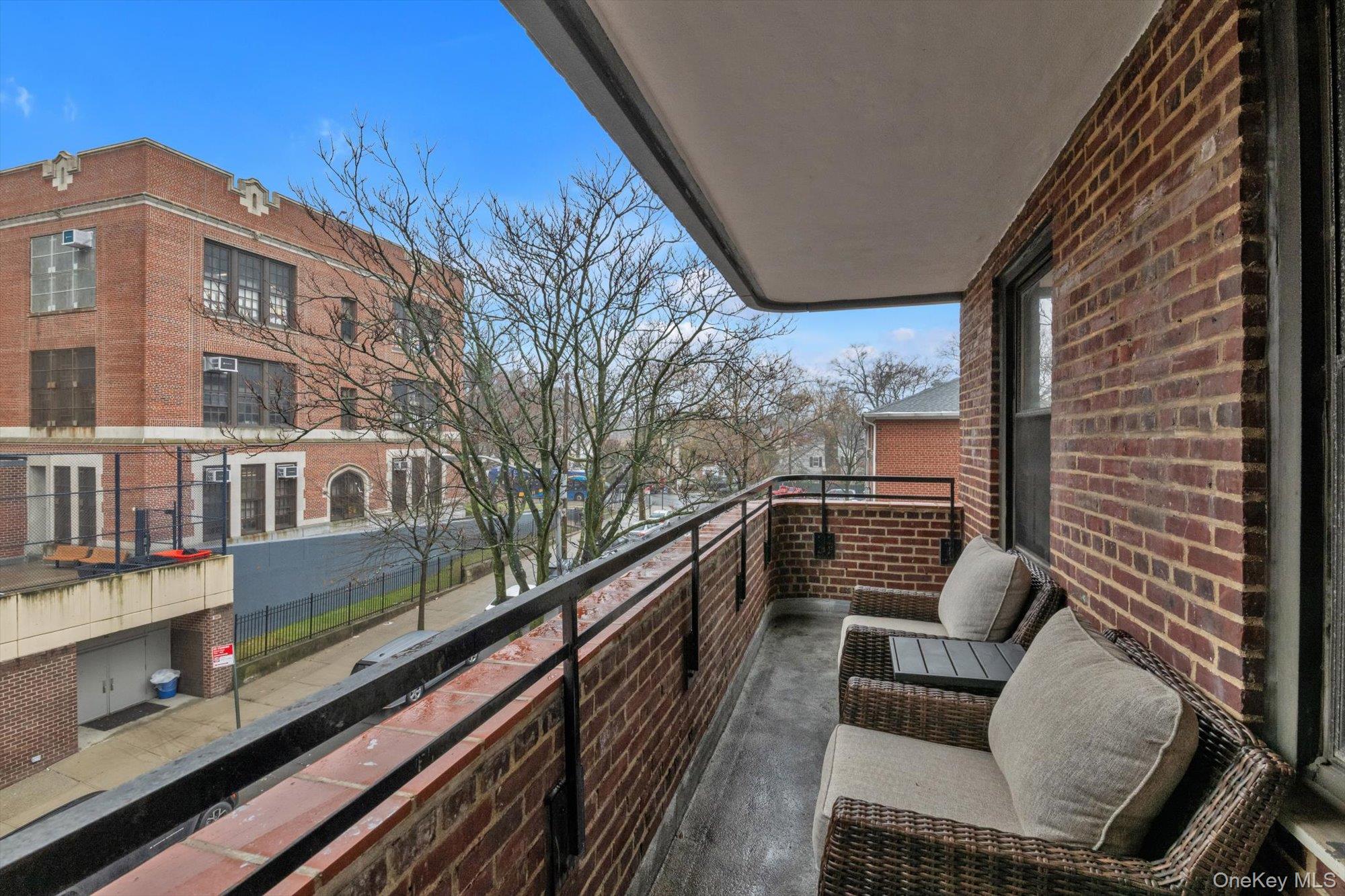 123-35 82nd Road, Unit 5C Queens, NY 11415 - Photo 18 of 21 a view of balcony with couch and wooden floor