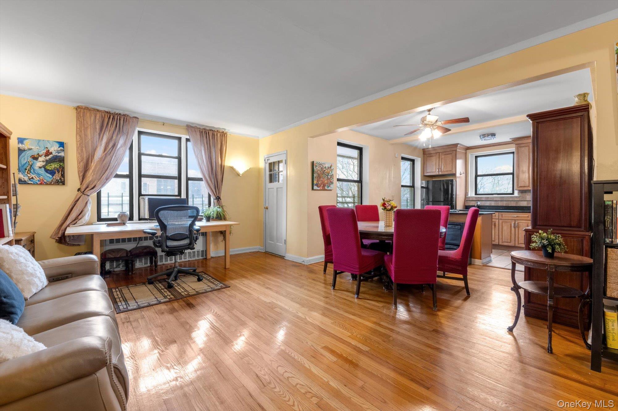 123-35 82nd Road, Unit 5C Queens, NY 11415 - Photo 6 of 21 a living room with furniture kitchen view and large windows