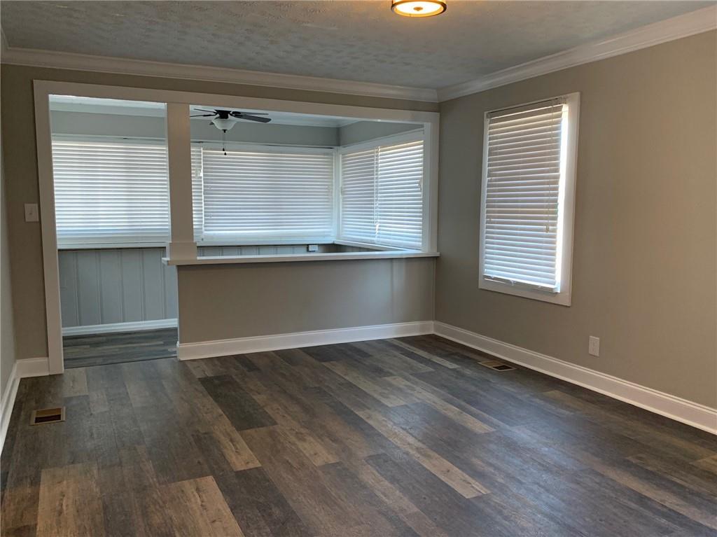 1261 Concord Road Southeast Smyrna, GA 30080 - Photo 5 of 50 an empty room with wooden floor and windows